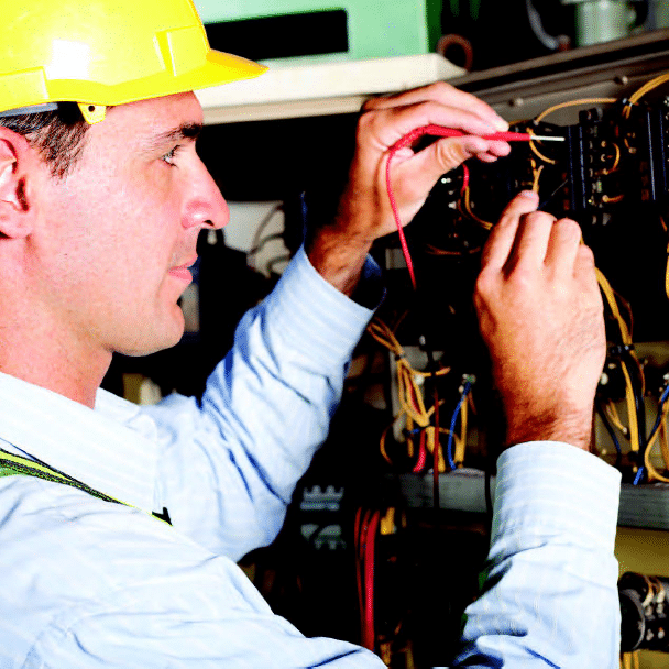 Man in hardhat working on electrical panel