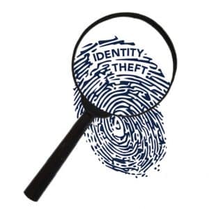 Magnifying glass showing thumbprint with word Identity Theft