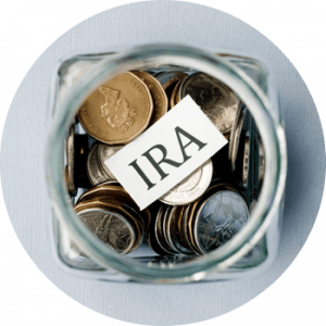 Coins in jar with piece of paper that reads IRA