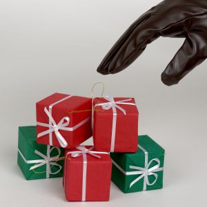Gloved hand reaching for wrapped gift boxes