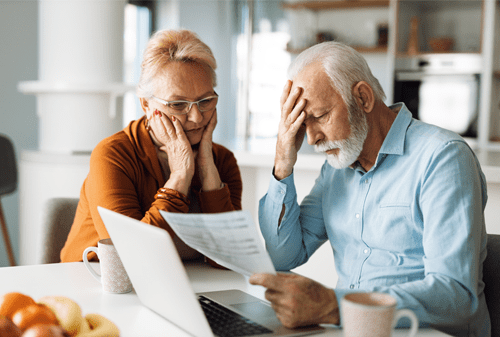 Worried senior couple feeling stressed while have to pay their bills over Internet