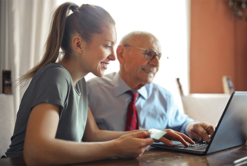 Older man discussing finances with younger family member