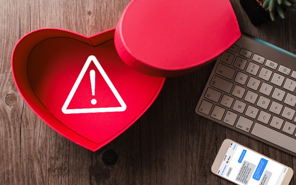 Valentines Day Hear Box alert icon romance scam text on a cellphone.