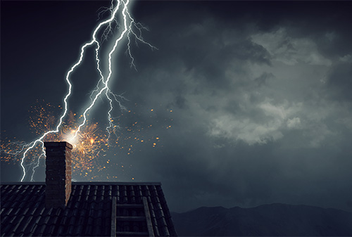 Chimney on top house being struck by lightning and sending sparks flying